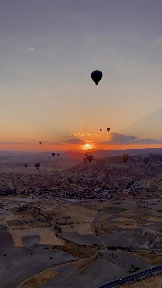 Cappadocia hot air balloons flying over Göreme at sunrise